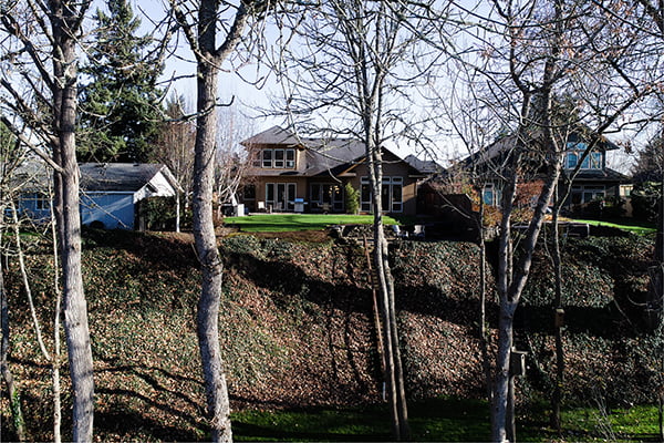Aerial view of backyard of home along river