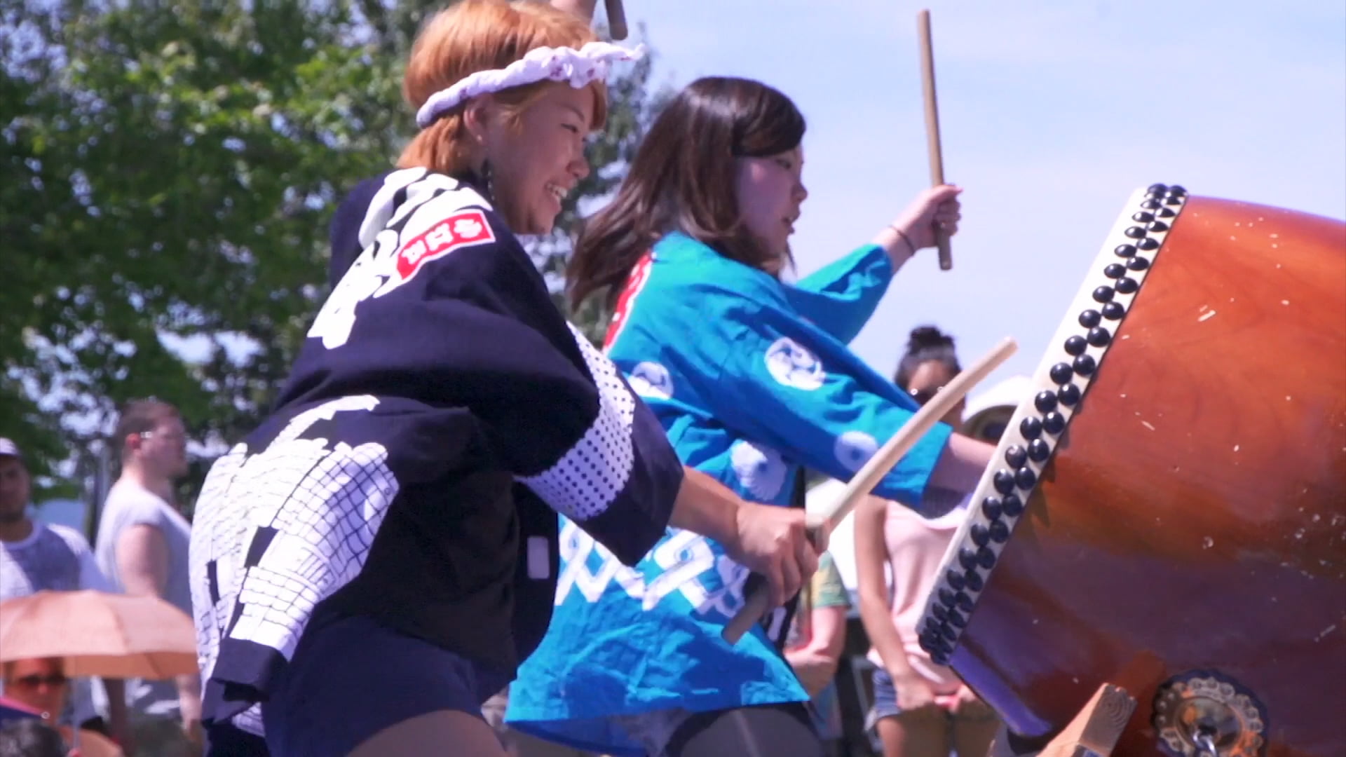 Image of two women playing traditional native drums