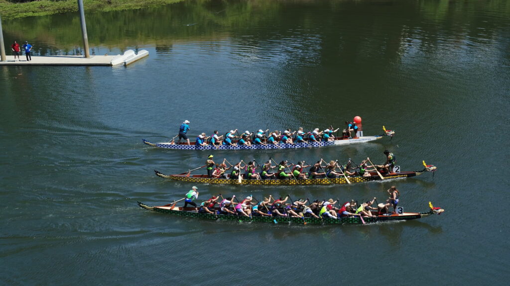 Three rowing teams racing in the Willamette River